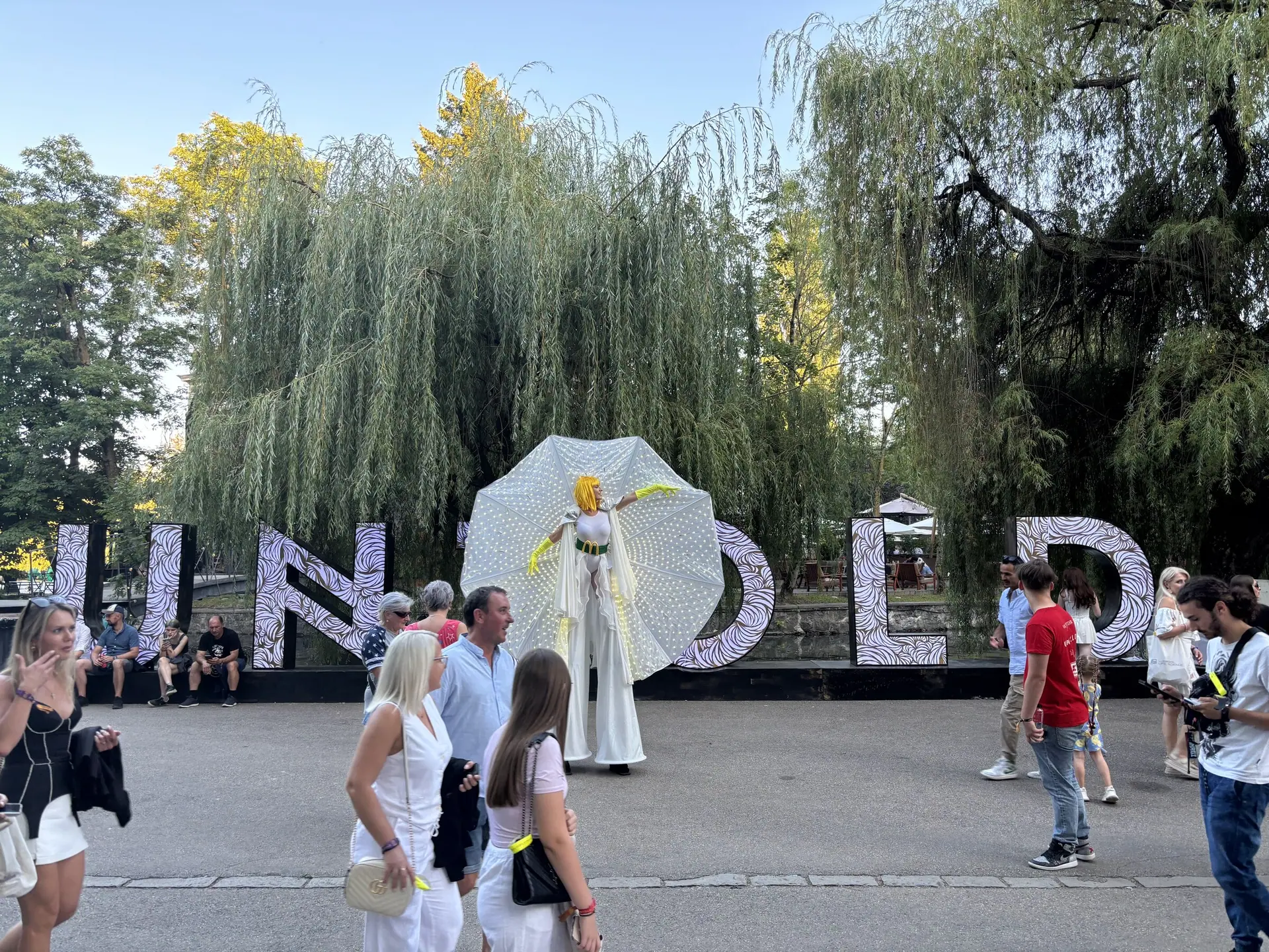 Two stilt characters, branded head to toe, carrying McDonald's above the heads of the crowd at the country's biggest festival.