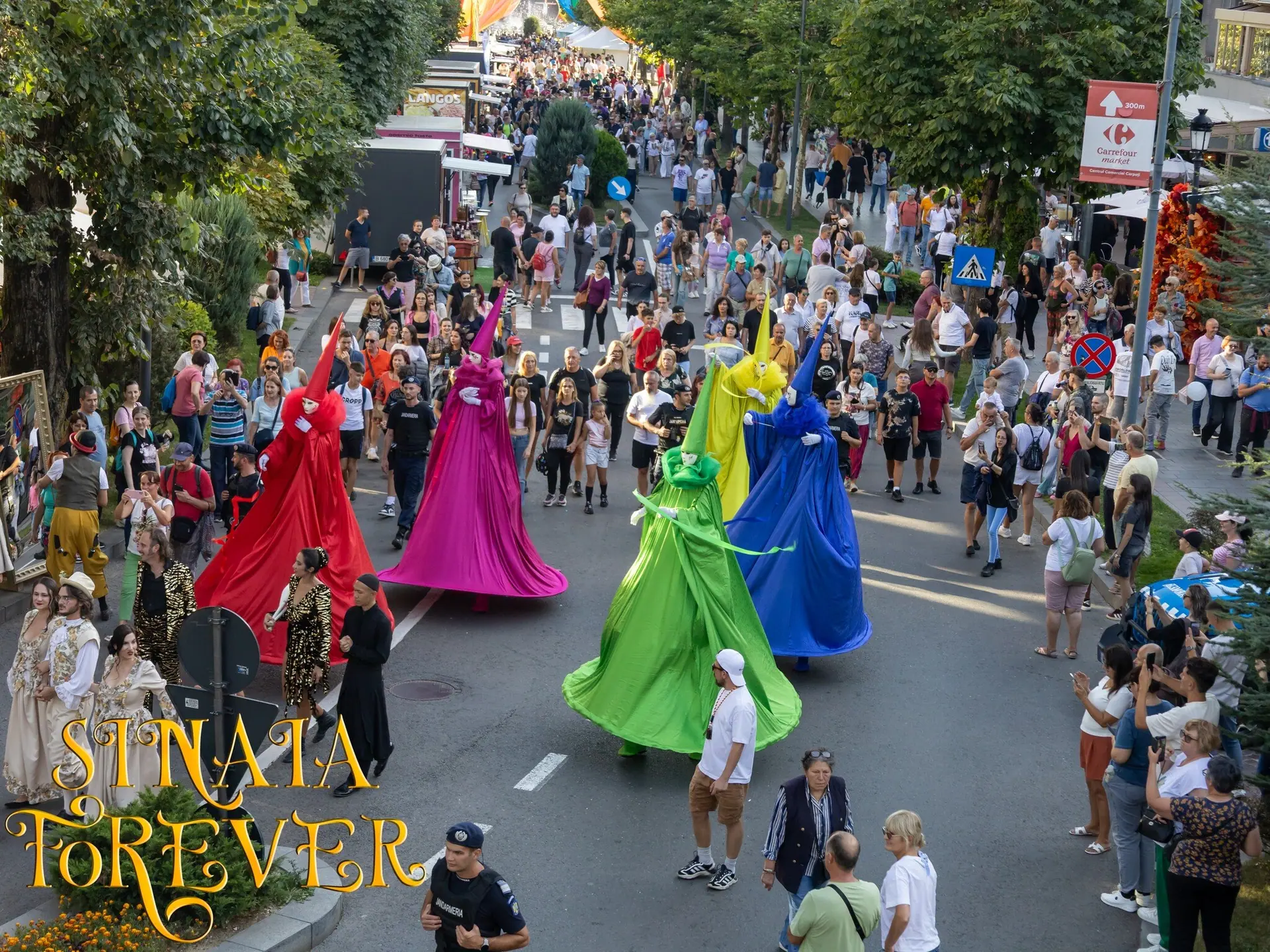 Three editions on the Sinaia promenade, a different cast each time: retro couples on stilts, neon, and in 2025 five colourful wizards with smoke.